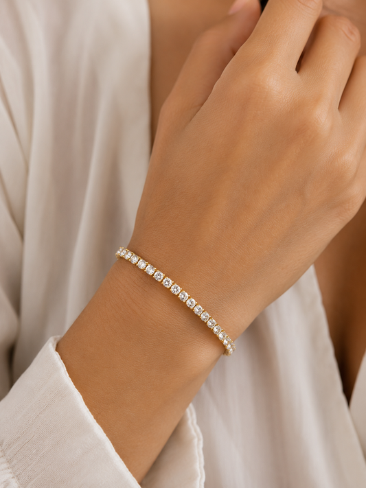 Woman wearing the Rosemere Dahlia gold tennis bracelet on the wrist, everyday styling
