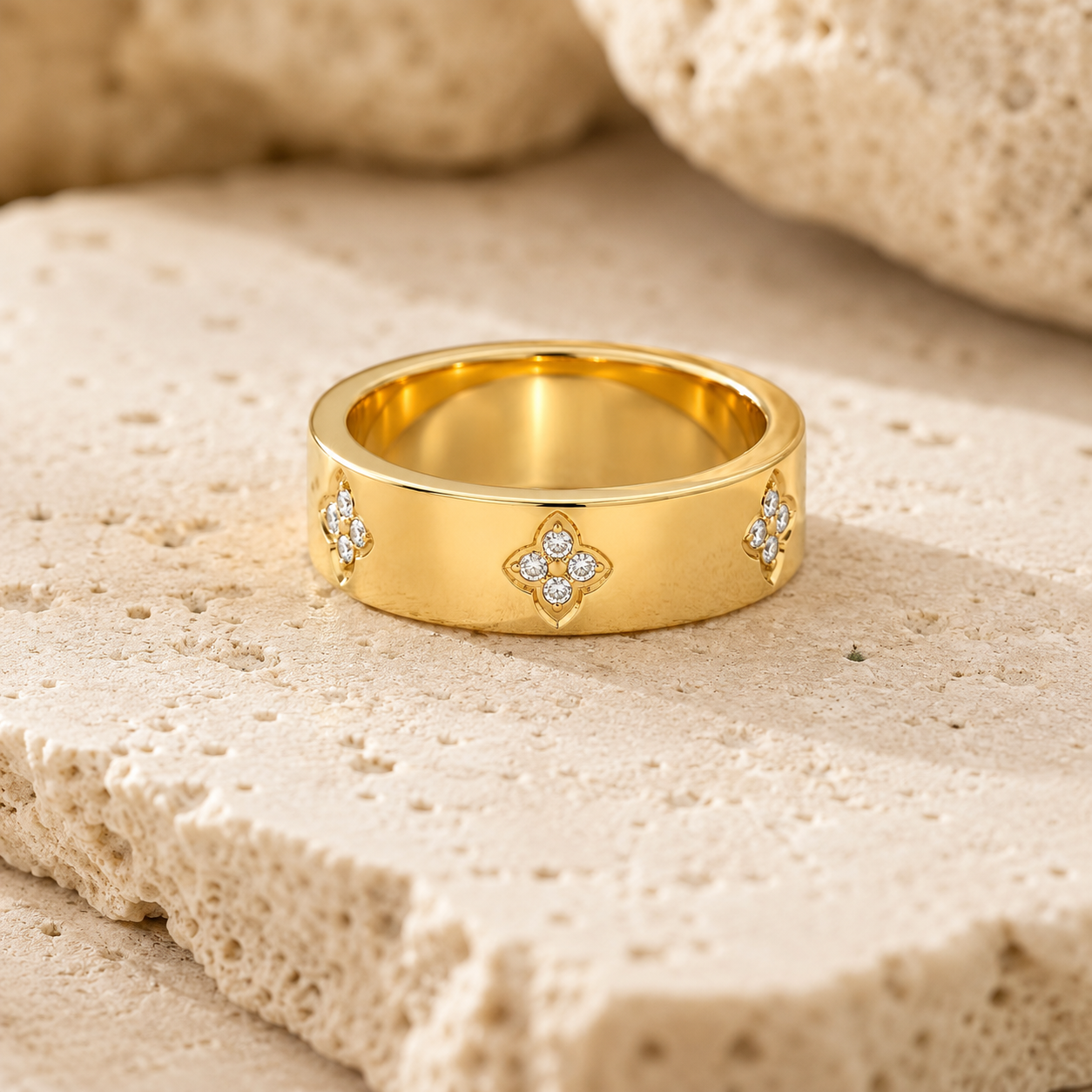 Rosemere Eloise gold band ring on natural stone in soft daylight