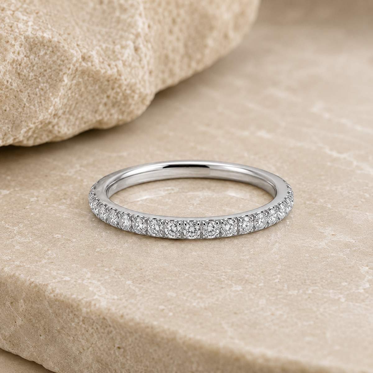 Rosemere Eterna silver pavé eternity ring on natural stone in soft daylight