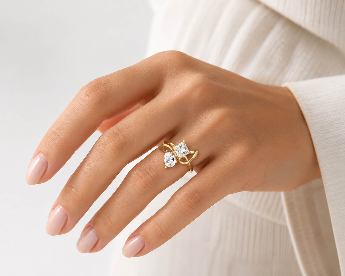 Woman wearing the Rosemere Vivienne crossover gold ring, everyday styling