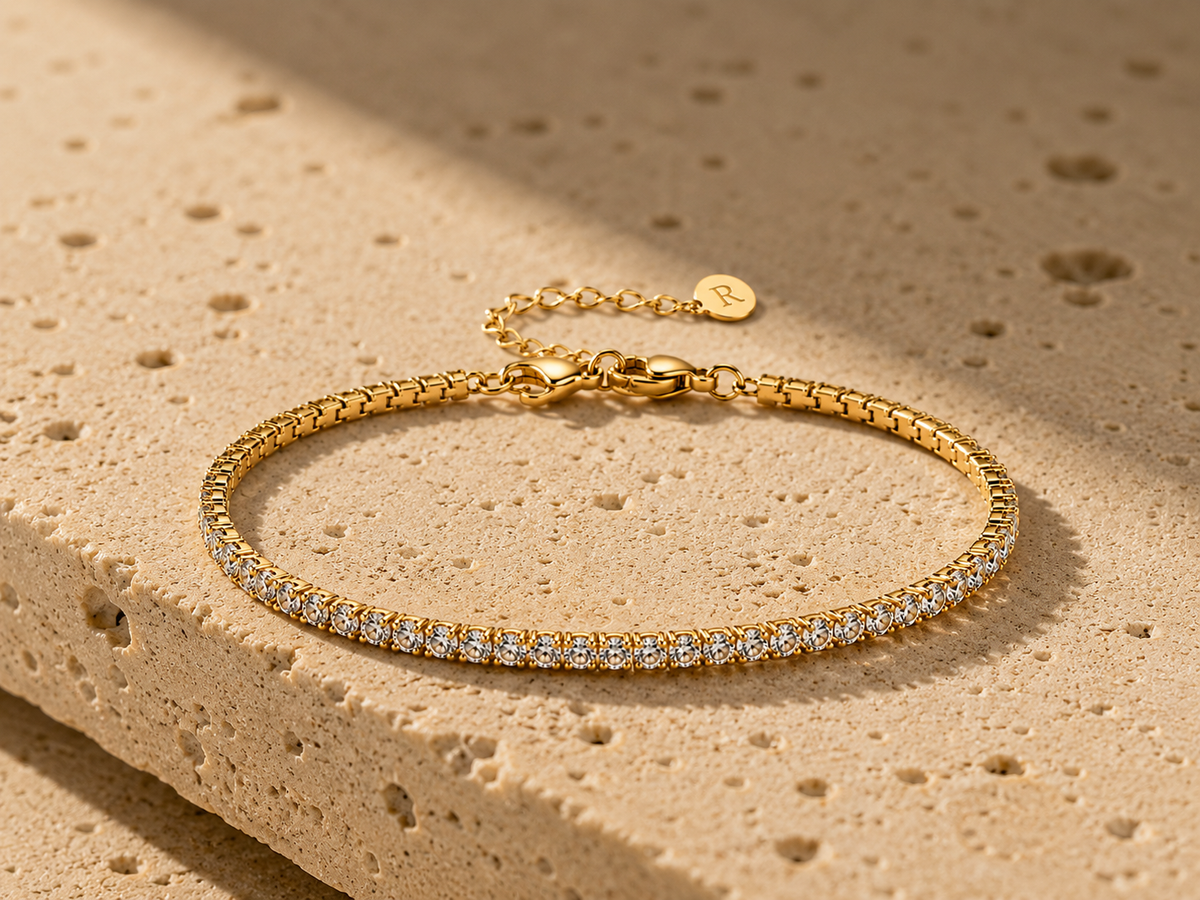 Rosemere Aureline gold tennis bracelet on natural stone in soft daylight