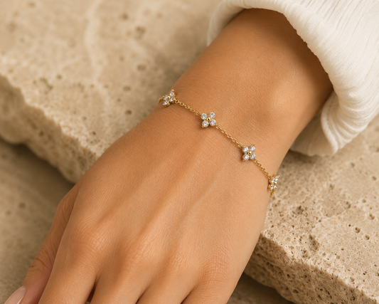 Woman wearing the Rosemere Lumi gold clover bracelet on the wrist, everyday styling