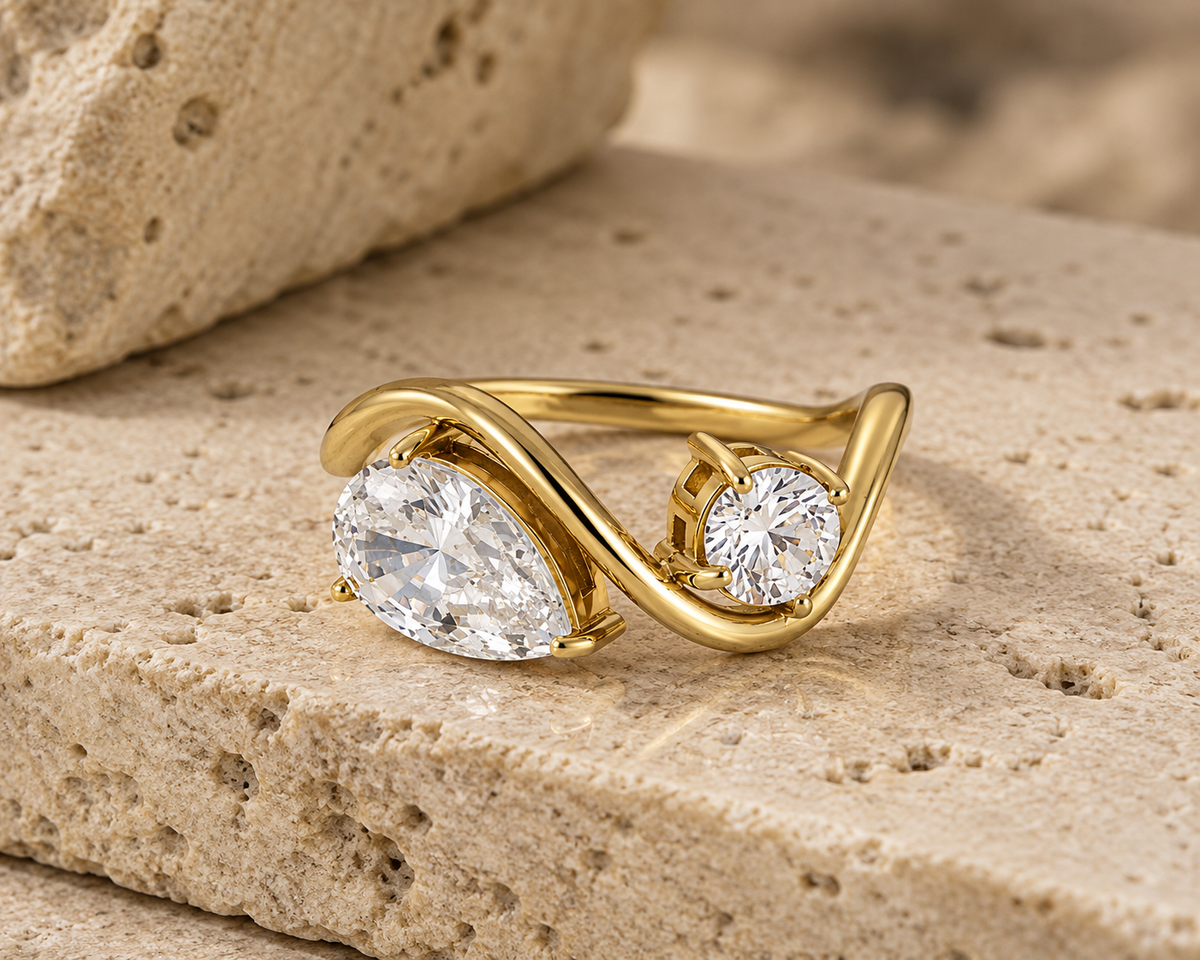 Rosemere Orielle twin-stone gold ring on natural stone in soft daylight