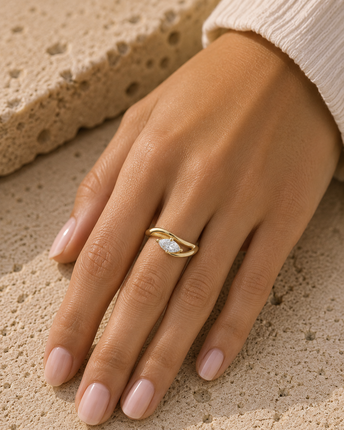 Woman wearing the Rosemere Selene marquise-cut gold ring, everyday styling