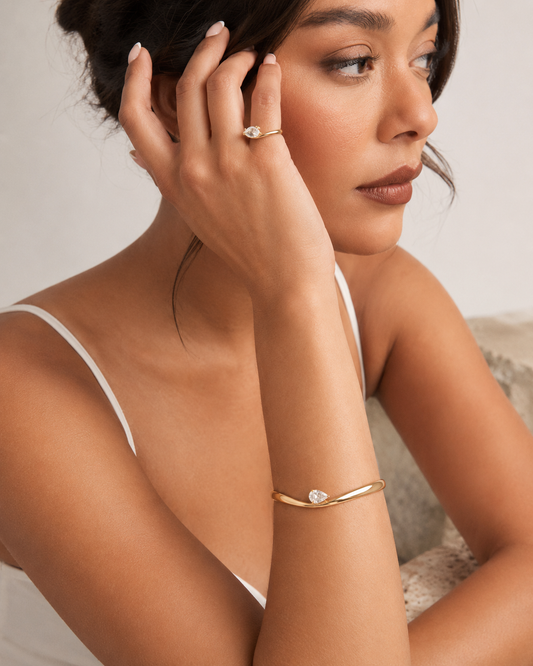 Woman wearing the Rosemere Vivienne gold cuff bangle, everyday styling